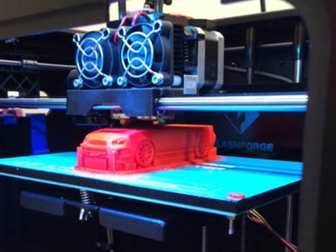 3D printer printing a model car