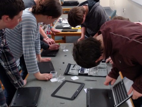 PIT Crew students repairing Chromebooks
